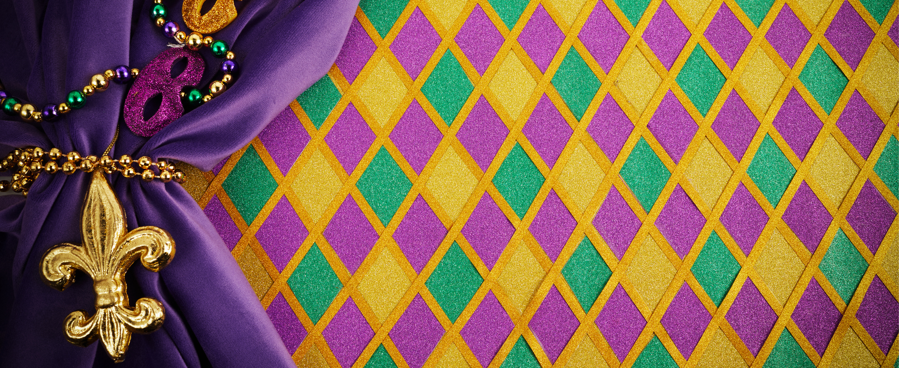 Frame of Mardi Gras Mask and Colorful Mardi Gras Beads on Diamond Shaped Background